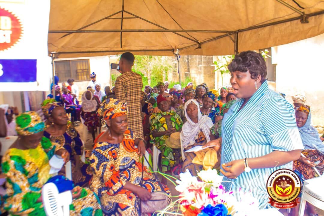 A foundation representative speaking with women during a community outreach in Ibadan